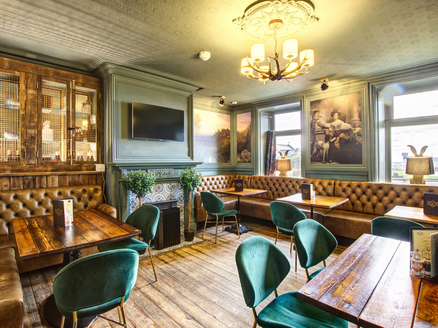 The green dining room with leather seating and original details