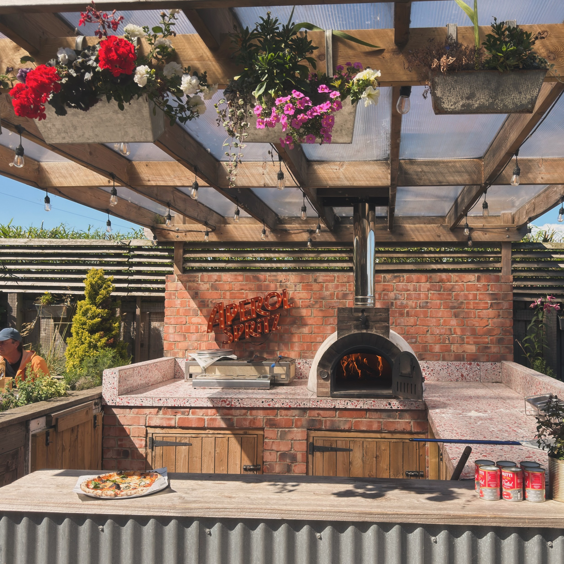 The wood fired pizza oven beneath flowers on the Delaval Arms terrace